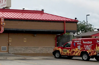 Famous Dave's BBQ Restaurant Exterior with catering truck sitting outside in the parking lot