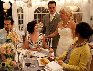 Couple at wedding talking to wedding guests